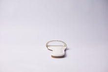 Load image into Gallery viewer, A single white flat sandal shown from the back on a seamless light gray studio background.