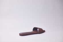 Load image into Gallery viewer, A single brown leather slide sandal with a wide strap and a contoured footbed, photographed from the side against a plain light gray background.