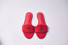 Load image into Gallery viewer, A pair of red slide sandals with textured straps and circular cutouts, displayed on a light gray background.